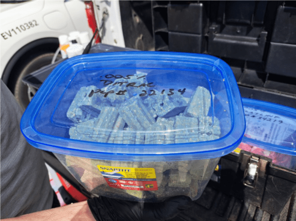 . A rodenticide, DITRAC ALL-WEATHER BLOX KILLS RATS & MICE (PCP # 22134), was stored in a container not designed for containing pesticides.